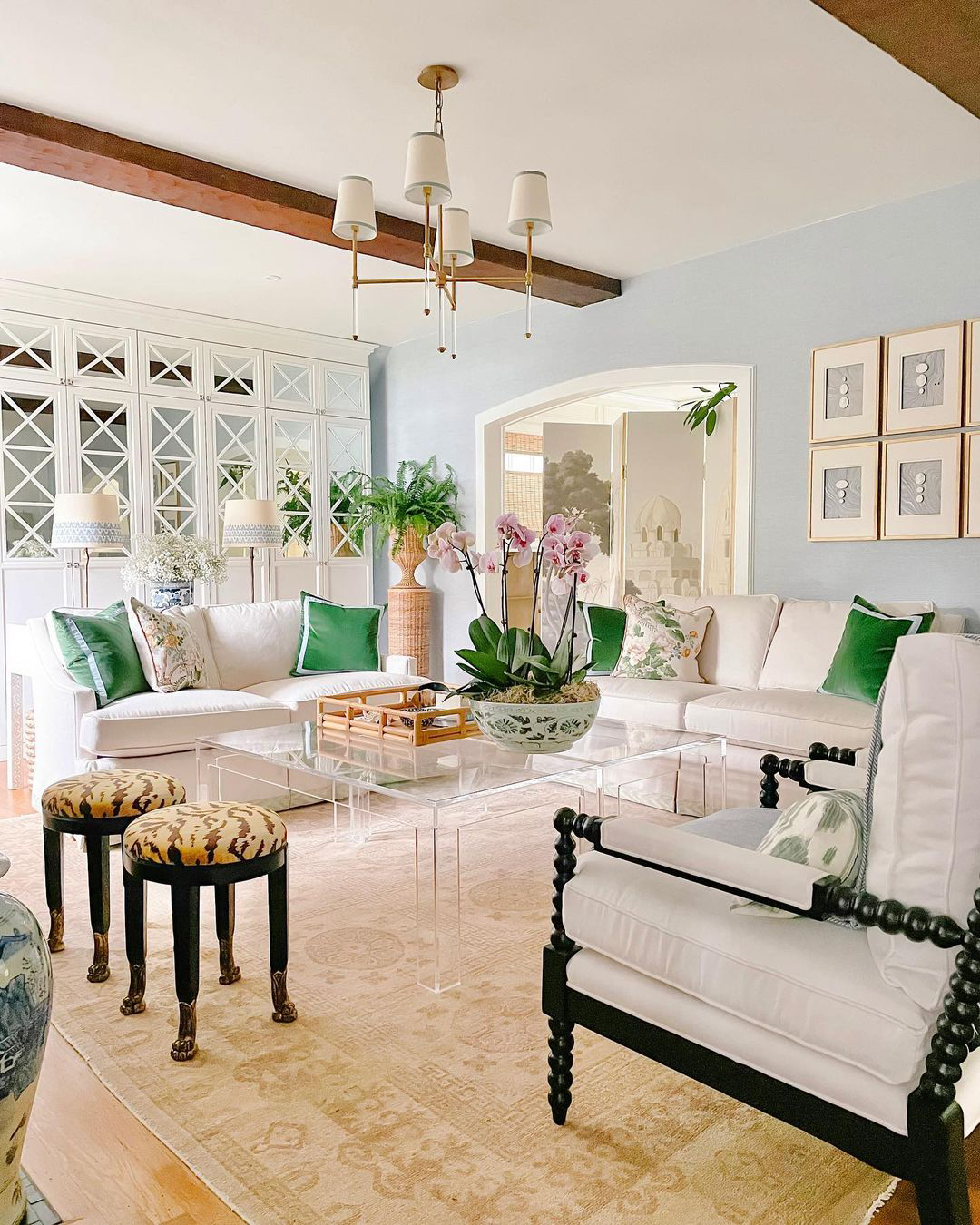 Elegant coastal grandmother sitting room with timeless furniture pieces brightened with pops of green and soft blue